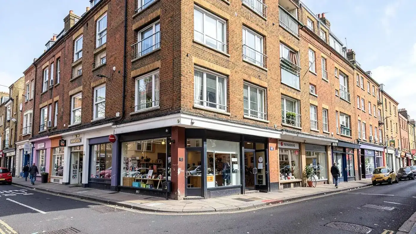 Mixed-use London building with shop units at street level and flats above
